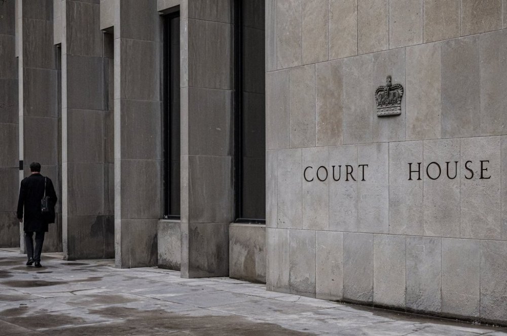 A person walks by the Ontario Superior Court in Toronto, on May 2, 2022. THE CANADIAN PRESS/Christopher Katsarov