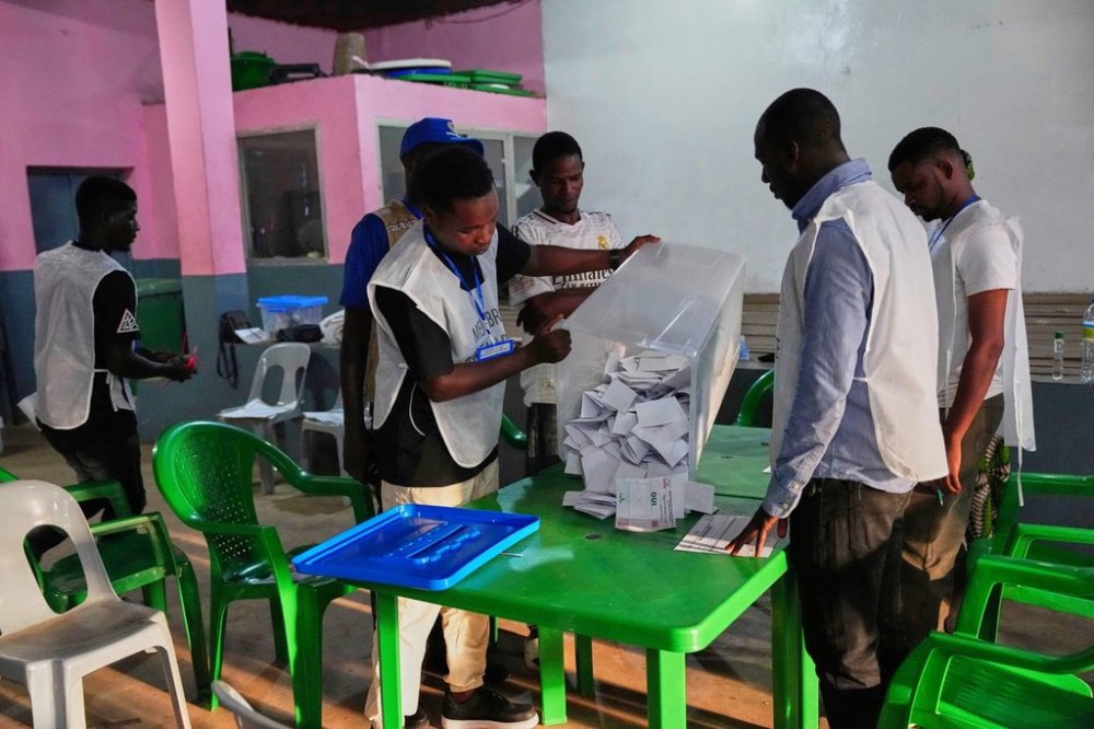 Voting slips are emptied from a ballot box at a polling station as polls close during the constitutional referendum in Conakry, Guinea, Sunday, Sept. 21, 2025. (AP Photo/Misper Apawu)