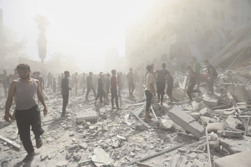 Palestinians inspect the rubble of a building after an Israeli military strike in Gaza City, Sunday, Sept. 14, 2025. (AP Photo/Yousef Al Zanoun)