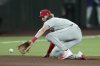 Philadelphia Phillies third baseman Alec Bohm fields a grounder hit by Arizona Diamondbacks' Tim Tawa before throwing to first base for the out during the fourth inning of a baseball game Friday, Sept. 19, 2025, in Phoenix. (AP Photo/Ross D. Franklin)