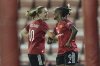 Manchester United's scorer Elisabeth Terland, left, and her teammate Melvine Malard, right, celebrate their side's third goal during the women's Champions League third qualifying round, second leg, soccer match between Manchester United and Brann in Leigh, England, Thursday, Sept. 18, 2025. (Barrington Coombs/PA via AP)