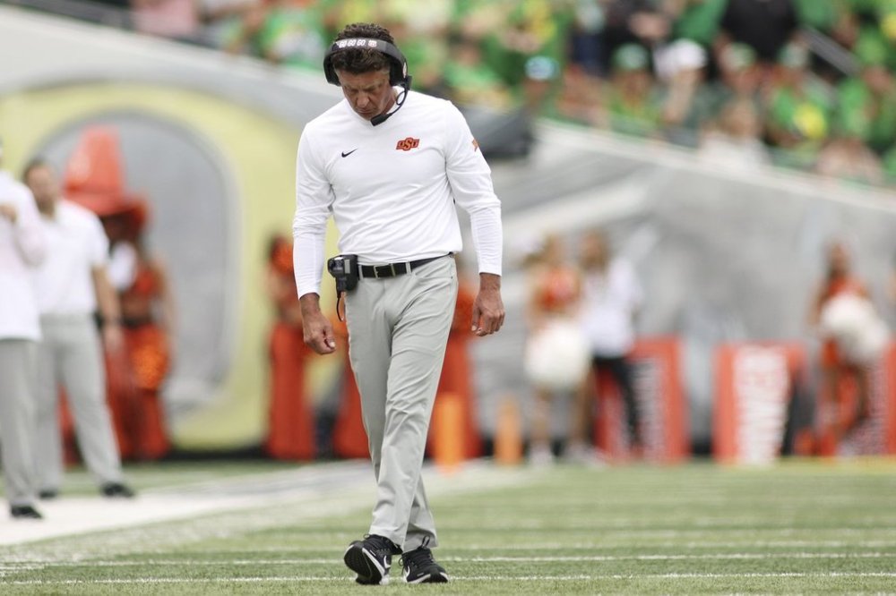 Oklahoma State head coach Mike Gundy walks on the field during the first half of an NCAA college football game, Saturday, Sept. 6, 2025, in Eugene, Ore. (AP Photo/Lydia Ely)