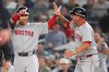Boston Red Sox outfielder Masataka Yoshida, left, celebrates with first base coach José David Flores after driving in two runs against the New York Yankees during the seventh inning of Game 1 of an American League wild-card baseball playoff series, Tuesday, Sept. 30, 2025, in New York. (AP Photo/Yuki Iwamura)