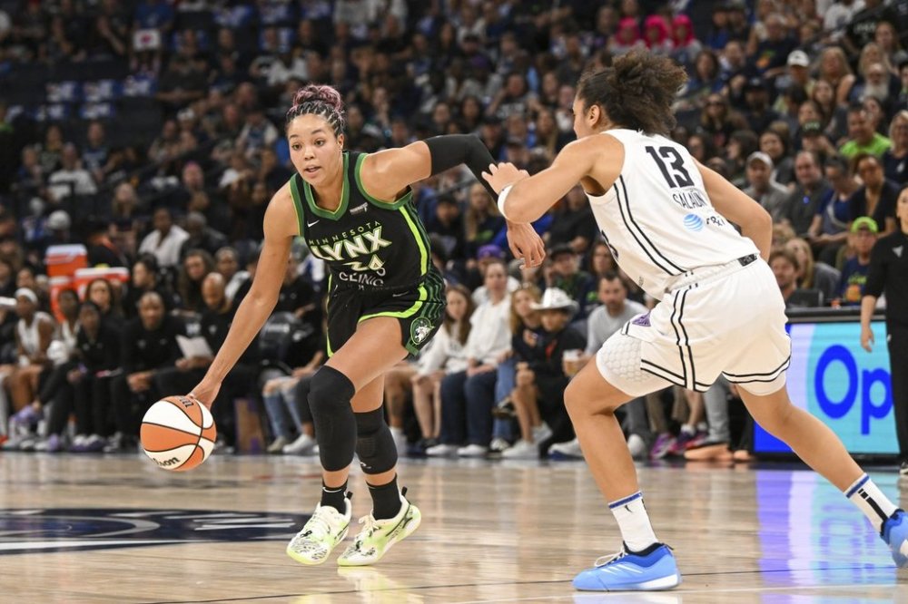 Minnesota Lynx forward Napheesa Collier, left, drives past Golden State Valkyries forward Janelle Salaun (13) during the second half of Game 1 in the first round of the WNBA basketball playoffs Sunday, Sept. 14, 2025, in Minneapolis. (AP Photo/Craig Lassig)