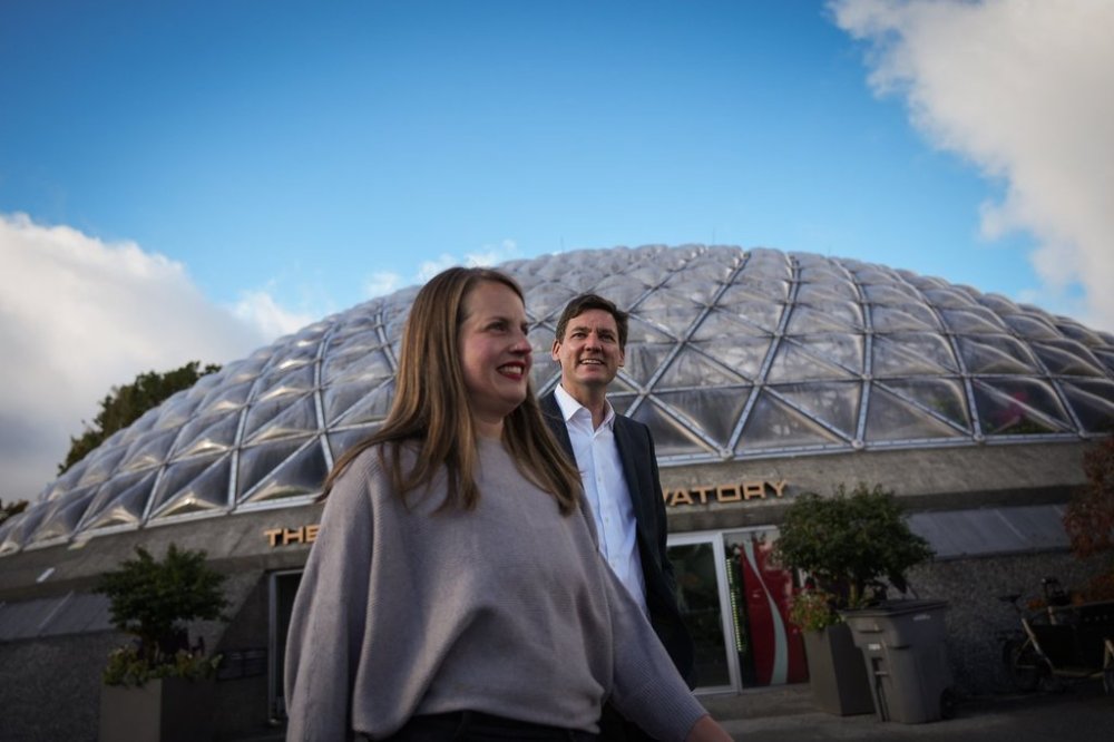 B.C. NDP Leader David Eby, back right, and Housing Minister Christine Boyle walk past the Bloedel Conservatory as they arrive for a campaign stop in Vancouver, B.C., Thursday, Oct. 17, 2024. THE CANADIAN PRESS/Darryl Dyck