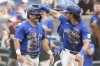 Blue Jays third baseman Addison Barger (right) and teammate Davis Schneider celebrate after scoring in the second inning of a Major League Baseball game in Toronto on Sept. 27, 2025. THE CANADIAN PRESS/Chris Young