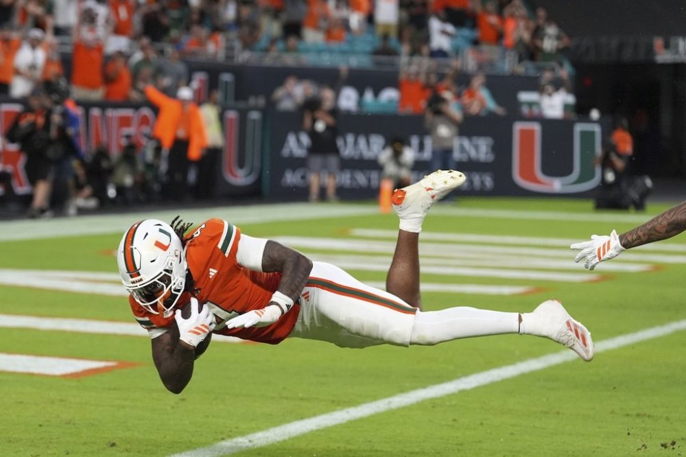 Miami running back Mark Fletcher Jr. scores a touchdown during the first half of an NCAA college football game against South Florida, Saturday, Sept. 13, 2025, in Miami Gardens, Fla. (AP Photo/Rebecca Blackwell)