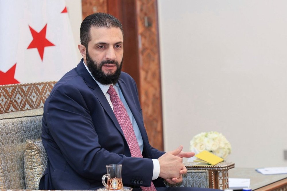 FILE - In this photo released by the Syrian official news agency SANA, Syria's interim President Ahmad al-Sharaa receives the final version of the provisional electoral system for the People's Assembly, in Damascus, Syria, Sunday, July 27, 2025. (SANA via AP, file)