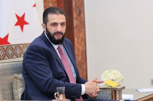 FILE - In this photo released by the Syrian official news agency SANA, Syria's interim President Ahmad al-Sharaa receives the final version of the provisional electoral system for the People's Assembly, in Damascus, Syria, Sunday, July 27, 2025. (SANA via AP, file)