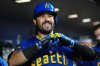 Seattle Mariners' Eugenio Suarez celebrates in the dugout after hitting a two-run home run during the second inning of a baseball game against the Colorado Rockies, Thursday, Sept. 25, 2025, in Seattle. (AP Photo/Ryan Sun)