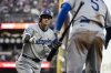 Los Angeles Dodgers Freddie Freeman (5) congratulates designated hitter Shohei Ohtani (17) after Ohtani hit a solo home run in the fourth inning of an MLB baseball game against the San Francisco Giants in San Francisco, Saturday, Sept. 13, 2025. (Stephen Lam/San Francisco Chronicle via AP)