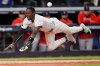 New York Yankees Jazz Chisholm Jr. dives into home plate to score on a hit by Austin Wells against the Boston Red Sox during the eighth inning of Game 2 of an American League wild-card baseball playoff series, Wednesday, Oct. 1, 2025, in New York. (AP Photo/Frank Franklin II)