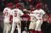 Los Angeles Angels' Chris Taylor (33) celebrates with Taylor Ward (3) designated hitter Mike Trout (27) after hitting a home run during the sixth inning of a baseball game against the Minnesota Twins, Tuesday, Sept. 9, 2025, in Anaheim, Calif. (AP Photo/Jessie Alcheh)