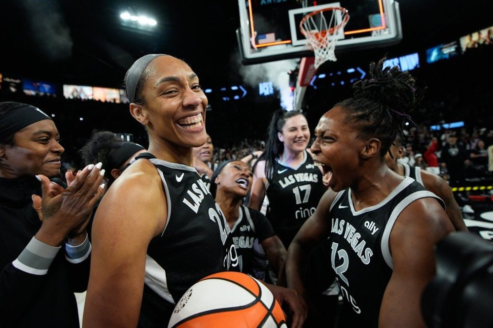 Las Vegas Aces center A'ja Wilson (22) and Las Vegas Aces guard Chelsea Gray (12) celebrate after the Las Vegas Aces defeated the Indiana Fever in Game 5 of a WNBA basketball playoff semifinals series Tuesday, Sept. 30, 2025, in Las Vegas. (AP Photo/John Locher)
