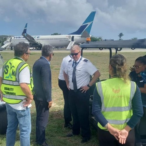 Members of the flight crew are shown near a WestJet plane after a hard landing at Princess Juliana International Airport in St. Maarten in this Sunday, Sept. 7, 2025, handout photo. THE CANADIAN PRESS/Handout - Government of Sint Maarten (Mandatory Credit)