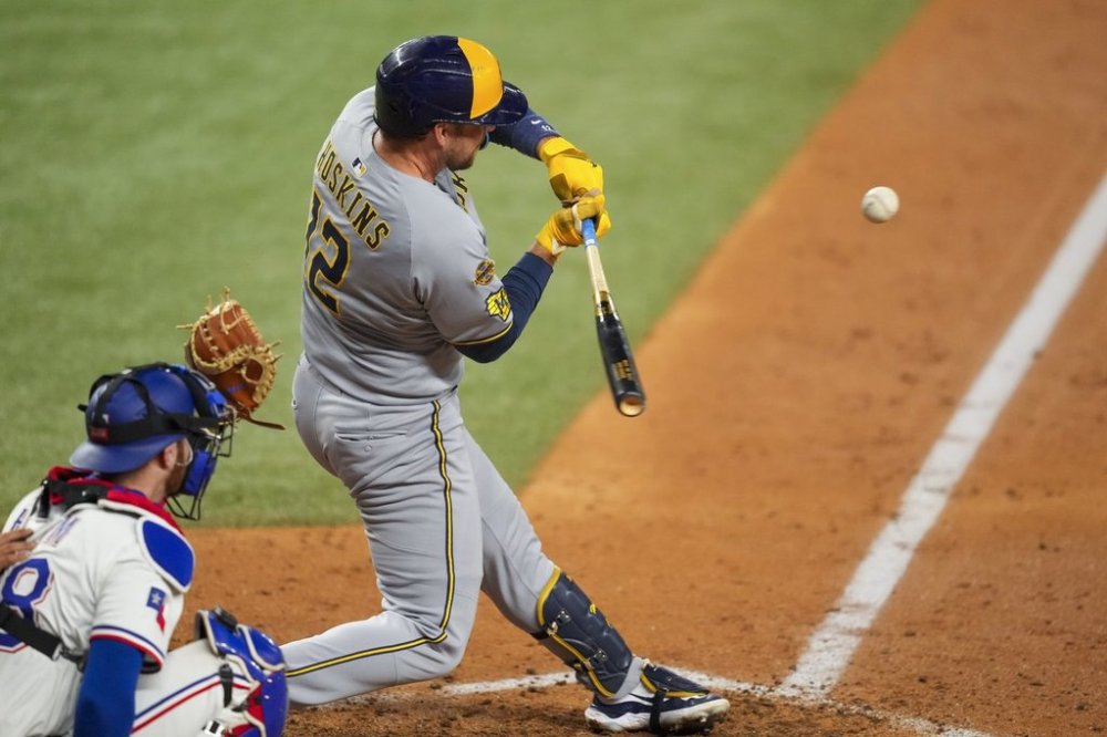 Milwaukee Brewers' Rhys Hoskins swings at a pitch during a pinch hit at bat against the Texas Rangers during the sixth inning of a baseball game Tuesday, Sept. 9, 2025, in Arlington, Texas. (AP Photo/Julio Cortez)
