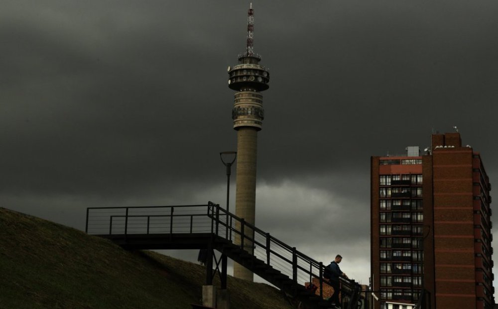 FILE - A man walks downstairs outside the Constitutional Court in Johannesburg, South Africa, on May 15, 2017. (AP Photo/Themba Hadebe, File)