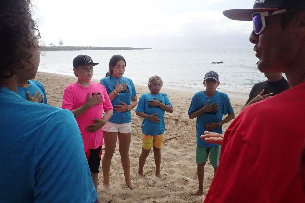 Maui Hero Project's Joseph Anderson, DayJahiah Valdivia, Ocean Viera and Ivan Macias follow Kahākūahi Ocean Academy's Zane Kekoa Schweitzer's breathing exercise to re-center themselves after the beach physical training and lifeguard skills training in Lahaina, Hawaii, on Tuesday, June 10, 2025. Anderson and Valdivia were affected by the August 2023, fires on Maui. (Kevin Fujii/Honolulu Civil Beat via AP)