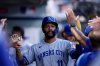 Kansas City Royals' Maikel Garcia (11) high fives teammates after scoring a run during the first inning of a baseball game against the Los Angeles Angels Tuesday, Sept. 23, 2025, in Anaheim, Calif. (AP Photo/Eric Thayer)