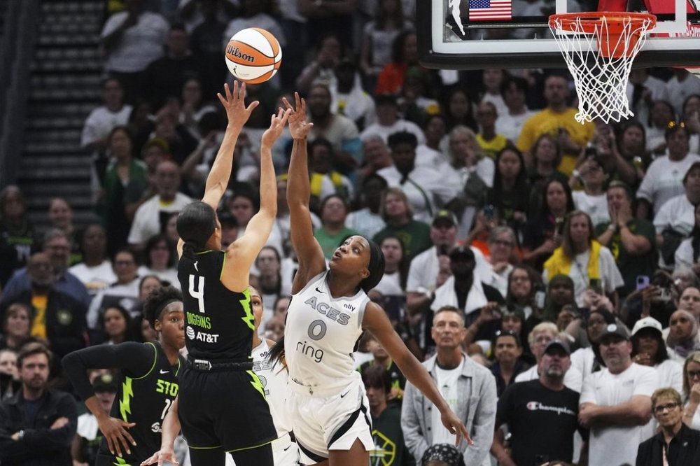 Seattle Storm guard Skylar Diggins (4) makes a shot over Las Vegas Aces guard Jackie Young (0) to give the Storm the lead during the second half of Game 2 in the first round of the WNBA basketball playoffs Tuesday, Sept. 16, 2025, in Seattle. (AP Photo/Lindsey Wasson)