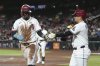 Arizona Diamondbacks' Geraldo Perdomo, left, celebrates his run scored against the San Francisco Giants with Diamondbacks' Ildemaro Vargas, right, during the first inning of a baseball game Monday, Sept. 15, 2025, in Phoenix. (AP Photo/Ross D. Franklin)