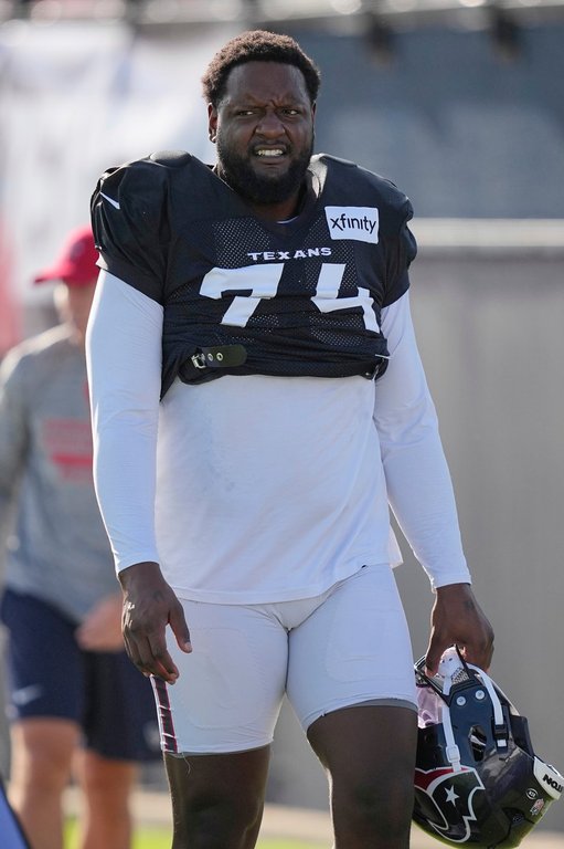 FILE - Houston Texans offensive tackle Cam Robinson walks across the field before an NFL football training camp practice Monday, July 28, 2025, in Houston. (AP Photo/David J. Phillip, file)