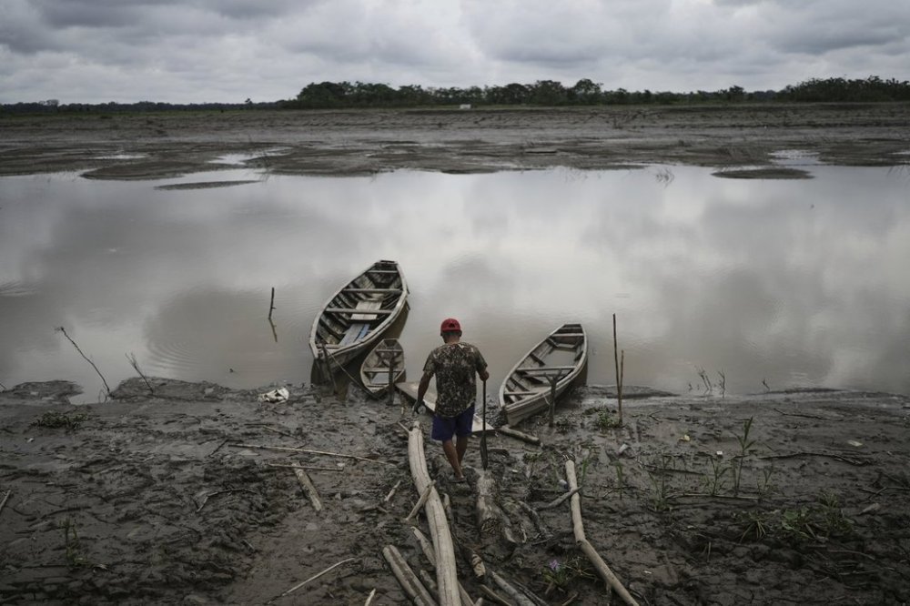 FILE - A fisherman walks to his boat in Santa Rosa, Peru, an island on the Amazon River on Aug. 17, 2025. (AP Photo/Ivan Valencia, File)
