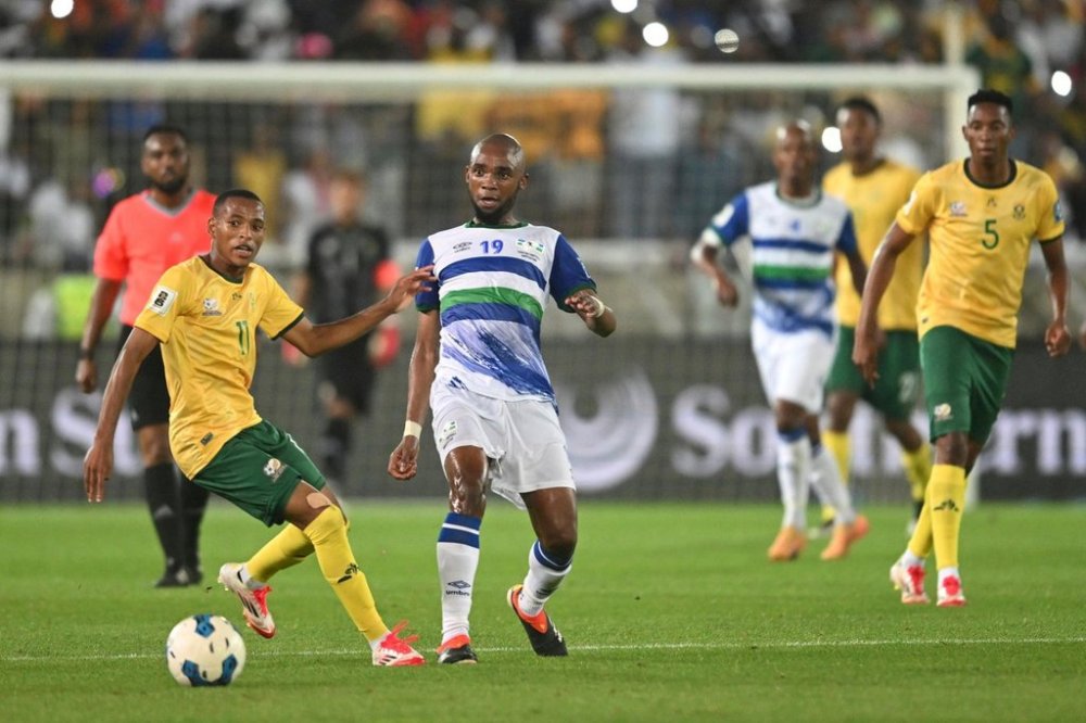 FILE - South Africa Relebohile Mofokeng, front left, challenges Lesotho Lehlohonolo Matsau, front right, during the World Cup qualifying match between South Africa and Lesotho, in Polokwane, South Africa, Friday, March 21, 2025. (AP Photo, File)