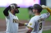 San Diego Padres' Xander Bogaerts, left, celebrates with Jackson Merrill (3) after hitting a home run during the first inning of a baseball game against the Arizona Diamondbacks Saturday, Sept. 27, 2025, in San Diego. (AP Photo/Gregory Bull)