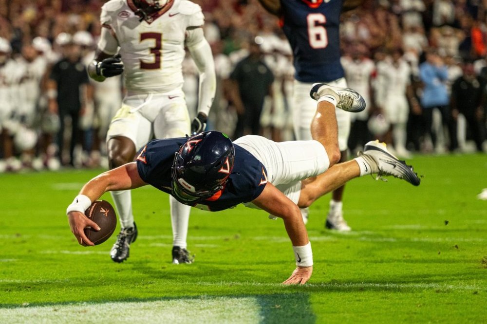 Virginia quarterback Chandler Morris (4) runs the ball in for a touchdown during the first half of an NCAA college football game, Friday, Sept. 26, 2025, in Charlottesville, Va. (AP Photo/Robert Simmons)