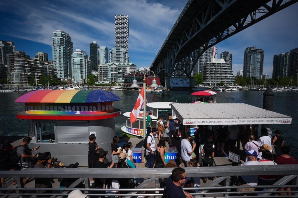 Tourists line up to take an Aquabus water taxi tour of False Creek, from Granville Island in Vancouver, B.C., Friday, Aug. 1, 2025. THE CANADIAN PRESS/Darryl Dyck