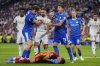 Marseille's goalkeeper Geronimo Rulli, bottom, gestures in pain after clashing with Real Madrid's Dani Carvajal, center, during a Champions League opening phase soccer match between Real Madrid and Marseille at Santiago Bernabeu stadium, in Madrid, Tuesday, Sept. 16, 2025. (AP Photo/Manu Fernandez)