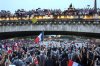 FILE - French athletes wave flags as they sail in a boat on the Seine River during the opening ceremony for the 2024 Summer Olympics in Paris, France, Friday, July 26, 2024. (Franck Fife/Pool Photo via AP, File)