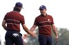 Europe's Tommy Fleetwood celebrates with Rory McIlroy on the third hole at Bethpage Black golf course during the Ryder Cup golf tournament, Saturday, Sept. 27, 2025, in Farmingdale, N.Y. (AP Photo/Lindsey Wasson)