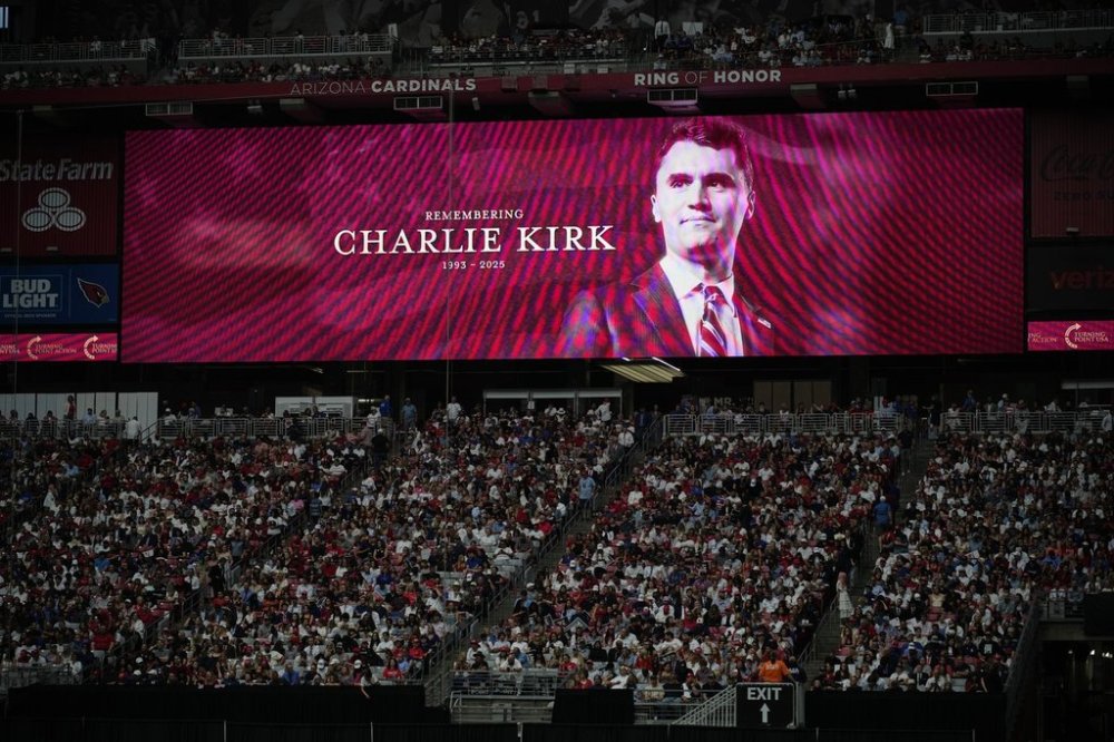 A photo of the conservative activist Charlie Kirk is seen on a large screen during a memorial for Kirk, Sunday, Sept. 21, 2025, at State Farm Stadium in Glendale, Ariz. (AP Photo/John Locher)