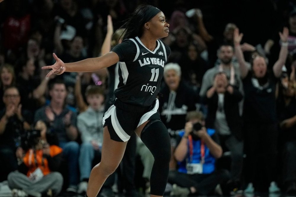 Las Vegas Aces guard Dana Evans (11) celebrates a three pointer against the Phoenix Mercury during the first half in Game 1 of a WNBA basketball final playoff series Friday, Oct. 3, 2025, in Las Vegas. (AP Photo/John Locher)
