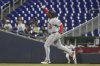 Washington Nationals' Josh Bell (19) gestures to the bullpen after hitting a three-run home run during the first inning of a baseball game against the Miami Marlins Tuesday, Sept. 9, 2025, in Miami. (AP Photo/Marta Lavandier)