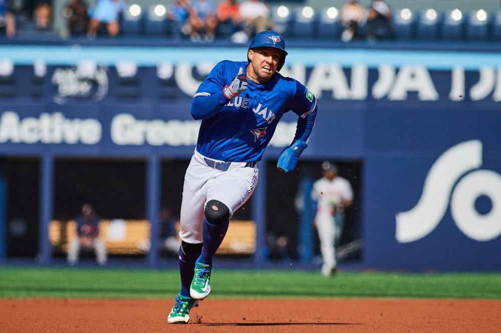 Toronto Blue Jays' George Springer (4) sprints to third as he scores against the Houston Astros during first inning MLB baseball action in Toronto, on Thursday, Sept. 11, 2025. THE CANADIAN PRESS/Sammy Kogan