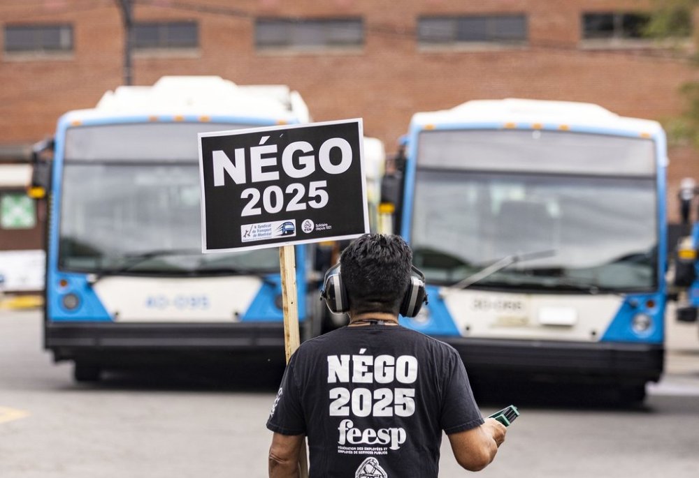 A Montreal transit agency mechanic protests outside their facility in Montreal on Monday, September 22, 2025. THE CANADIAN PRESS/Christinne Muschi