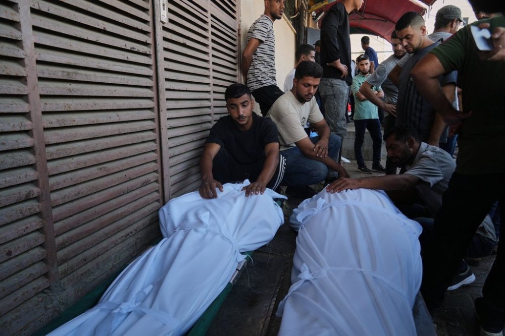 Mourners attend the funeral of Palestinians killed in an Israeli army strike, outside Al-Aqsa Hospital in Deir al-Balah, central Gaza Strip, Saturday, Oct. 4, 2025. (AP Photo/Abdel Kareem Hana)