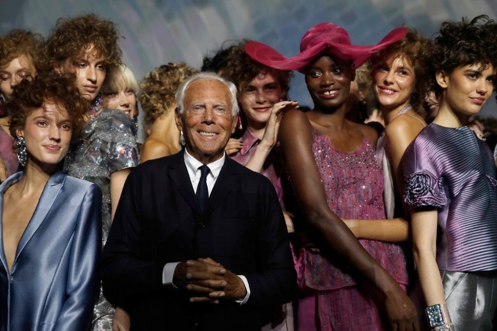 FILE - Designer Giorgio Armani, centre, poses with models at the end of his women's 2019 Spring-Summer collection, unveiled during the Fashion Week in Milan, Italy, Sunday, Sept. 23, 2018. (AP Photo/Luca Bruno, File)