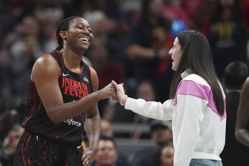 Indiana Fever's Aliyah Boston, left, talks with Caitlin Clark during the first half of a WNBA basketball game against the Minnesota Lynx, Tuesday, Sept. 9, 2025, in Indianapolis. (AP Photo/Darron Cummings)