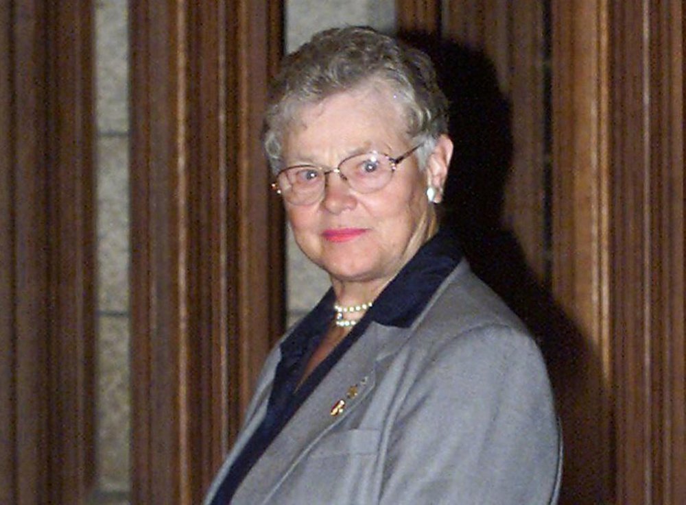 Senator in waiting Ione Christensen waits outside the Senate Chambers to be sworn-in as senator, during a private ceremony in the Senate in Ottawa on Sept. 7, 1999. THE CANADIAN PRESS/Fred Chartrand