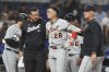 Detroit Tigers' Javier Baez (28) is led from the field after being hit by a foul tip during the second inning of a baseball game against the Miami Marlins, Friday, Sept. 12, 2025, in Miami. (AP Photo/Lynne Sladky)