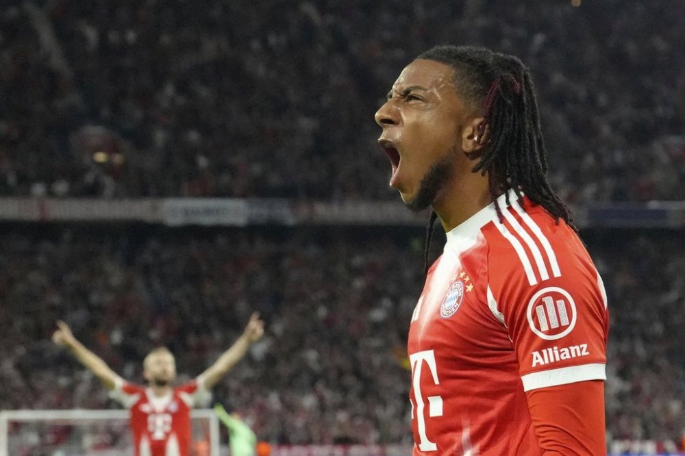 Bayern's Michael Olise after Chelsea's Trevoh Chalobah scored an own goal during the Champions League opening phase soccer match between FC Bayern Munich and Chelsea at the Allianz Arena in Munich, Germany, Wednesday, Sept. 17, 2025. (AP Photo/Martin Meissner)