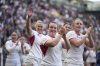 England players celebrate after defeating France during the Women's Rugby World Cup 2025 semifinal match between France and England in Bristol, England, Saturday, Sept. 20, 2025.(AP Photo/Alastair Grant)