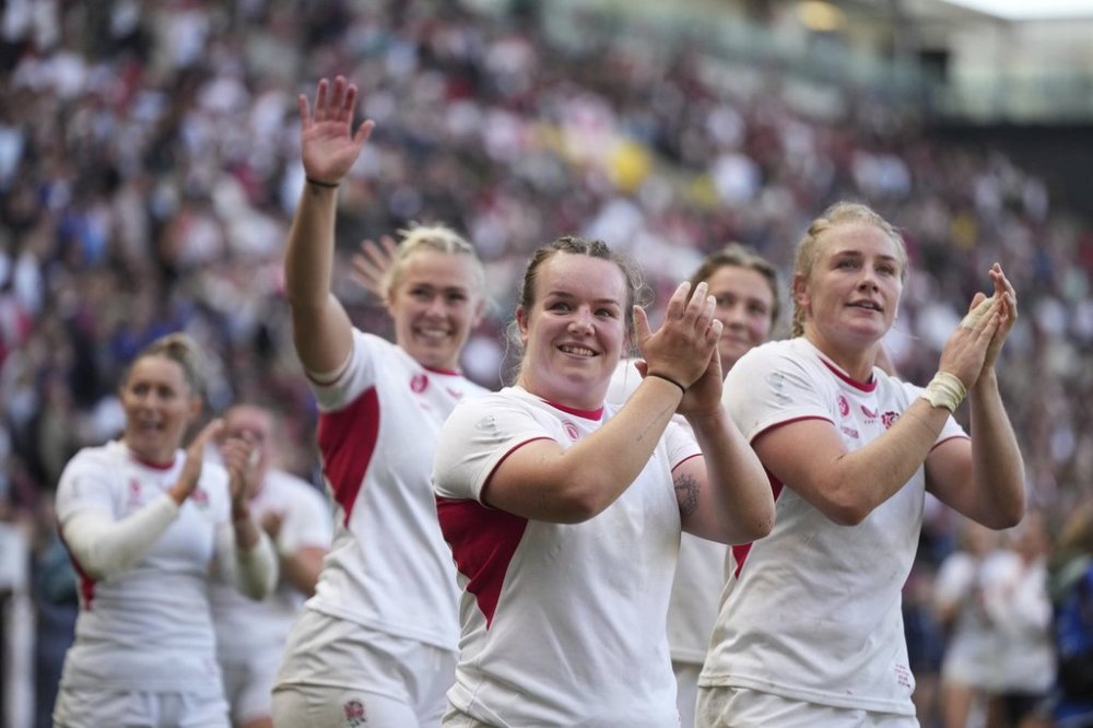 England players celebrate after defeating France during the Women's Rugby World Cup 2025 semifinal match between France and England in Bristol, England, Saturday, Sept. 20, 2025.(AP Photo/Alastair Grant)