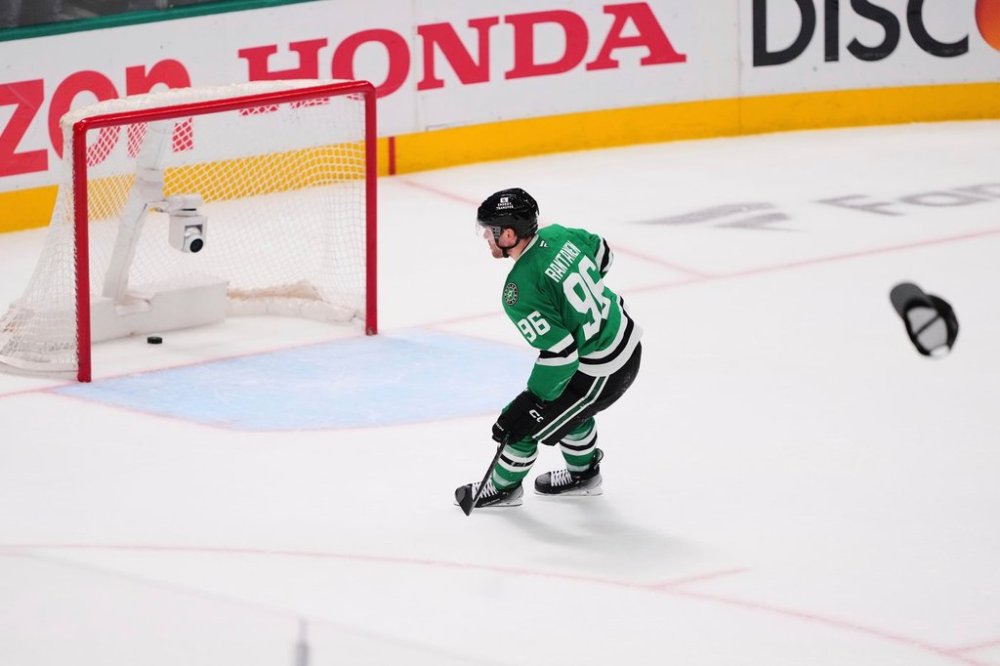 FILE - A hat is thrown onto the ice as Dallas Stars' Mikko Rantanen (96) scores an empty-net goal against to earn a hat trick in the third period in Game 7 of a first-round NHL hockey playoff series againts the Colorado Avalanche Saturday, May 3, 2025, in Dallas. (AP Photo/Julio Cortez, file)
