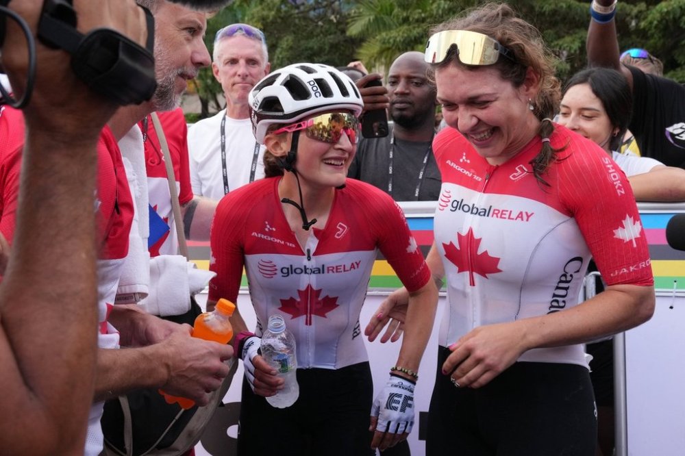 Canada's Magdeleine Vallieres Mill, centre, celebrates winning the women's Elite road race, at the road cycling World Championships in Kigali, Rwanda, Saturday, Sept. 27, 2025. (AP Photo/Jerome Delay)