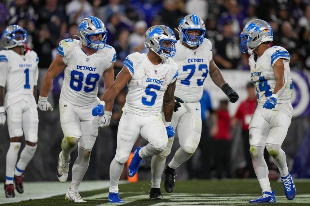 Detroit Lions running back David Montgomery (5) celebrates his touchdown run with teammates wide receiver Jameson Williams (1), tight end Brock Wright (89), guard Christian Mahogany (73) and wide receiver Amon-Ra St. Brown (14) during the second half of an NFL football game against the Baltimore Ravens Monday, Sept. 22, 2025, in Baltimore. (AP Photo/Stephanie Scarbrough)